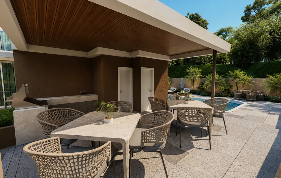 Área de barbacoa techada con mesas y sillas junto a la piscina